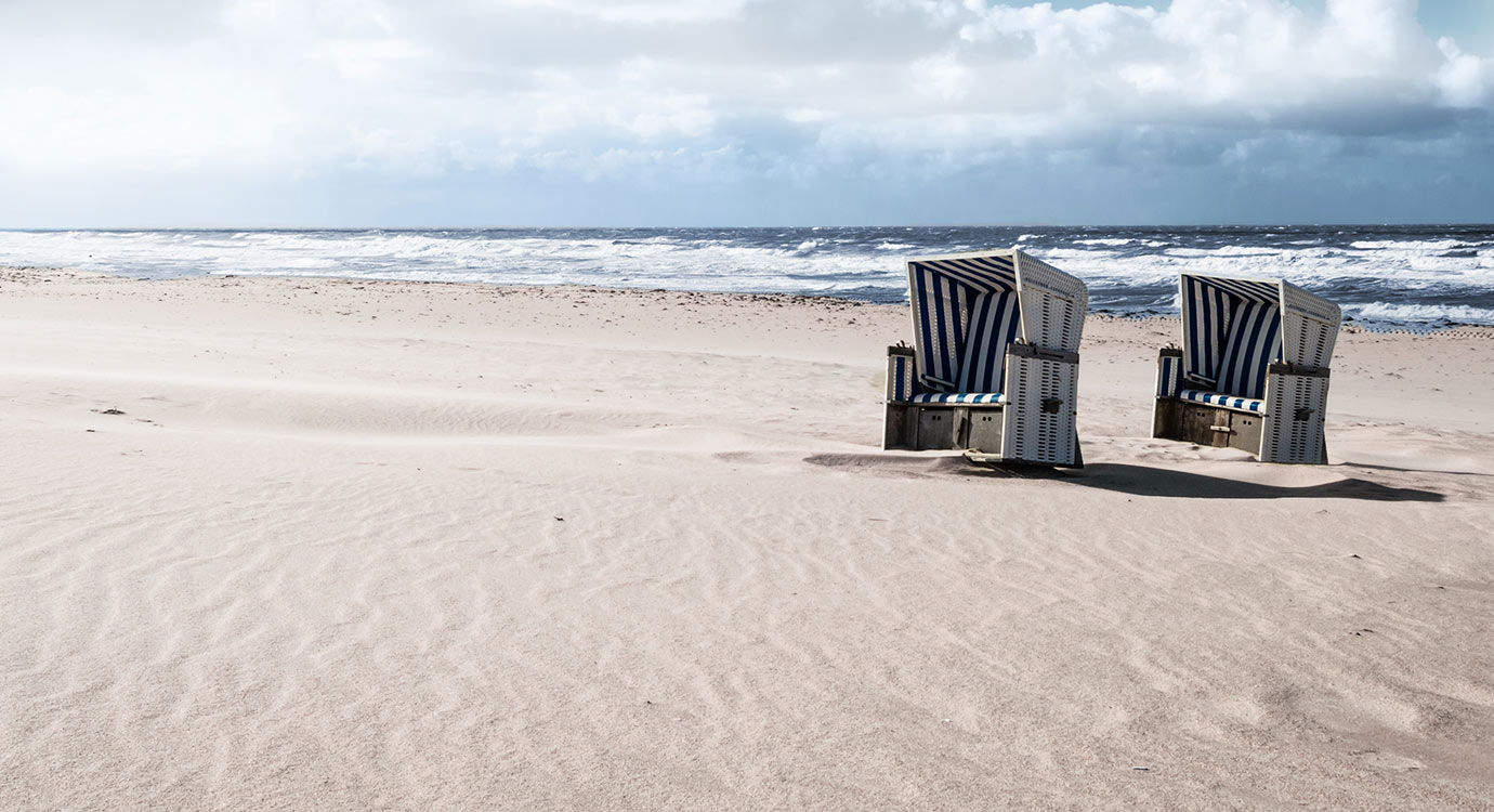 Image of empty beach with beach chairs